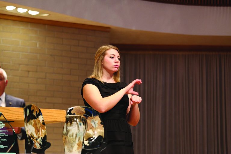 Mia Engle interpreting through sign language.
