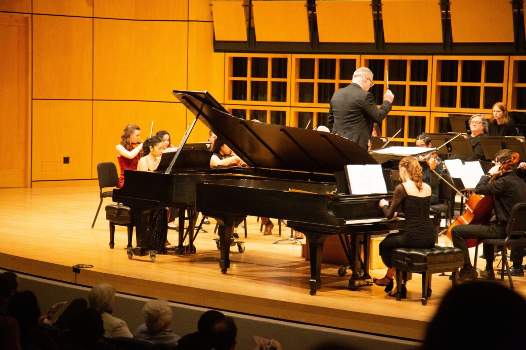 pianist plays in front of orchestra