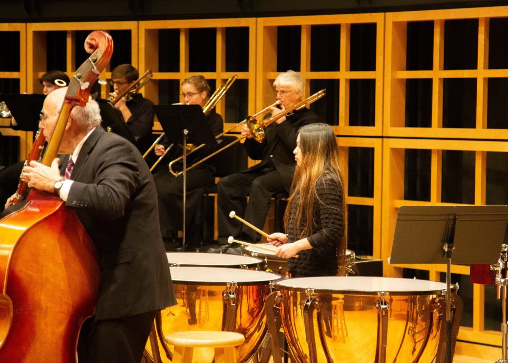 student playing large drums