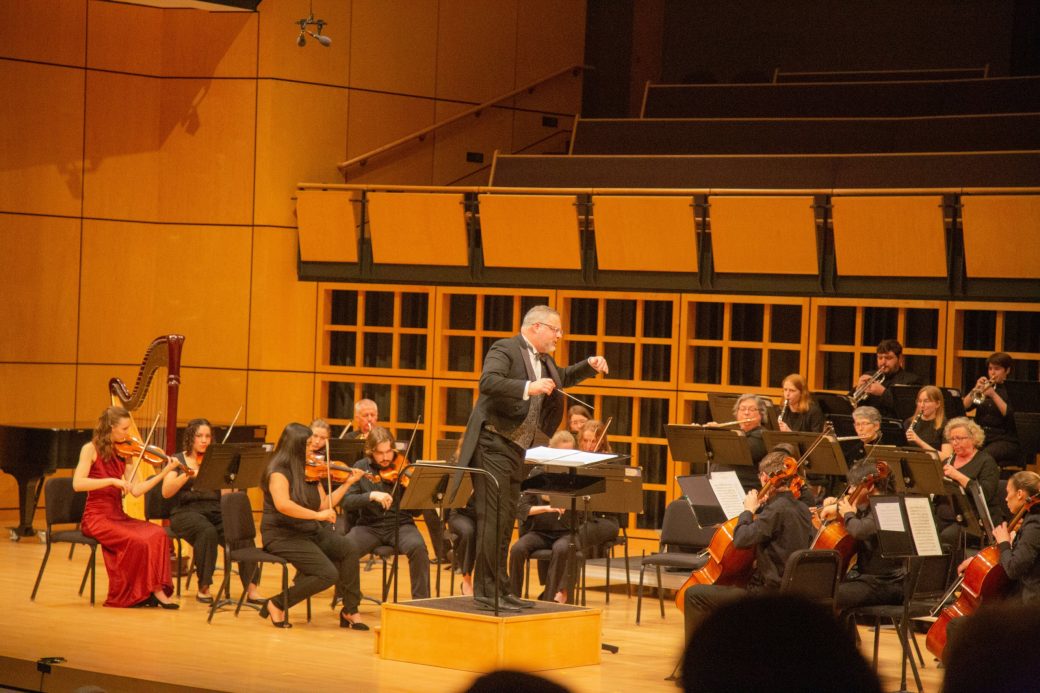 conductor leading rchestra infront of string section
