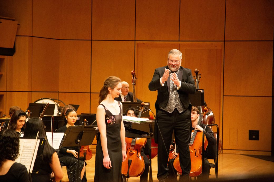 conductor applauds for soloist