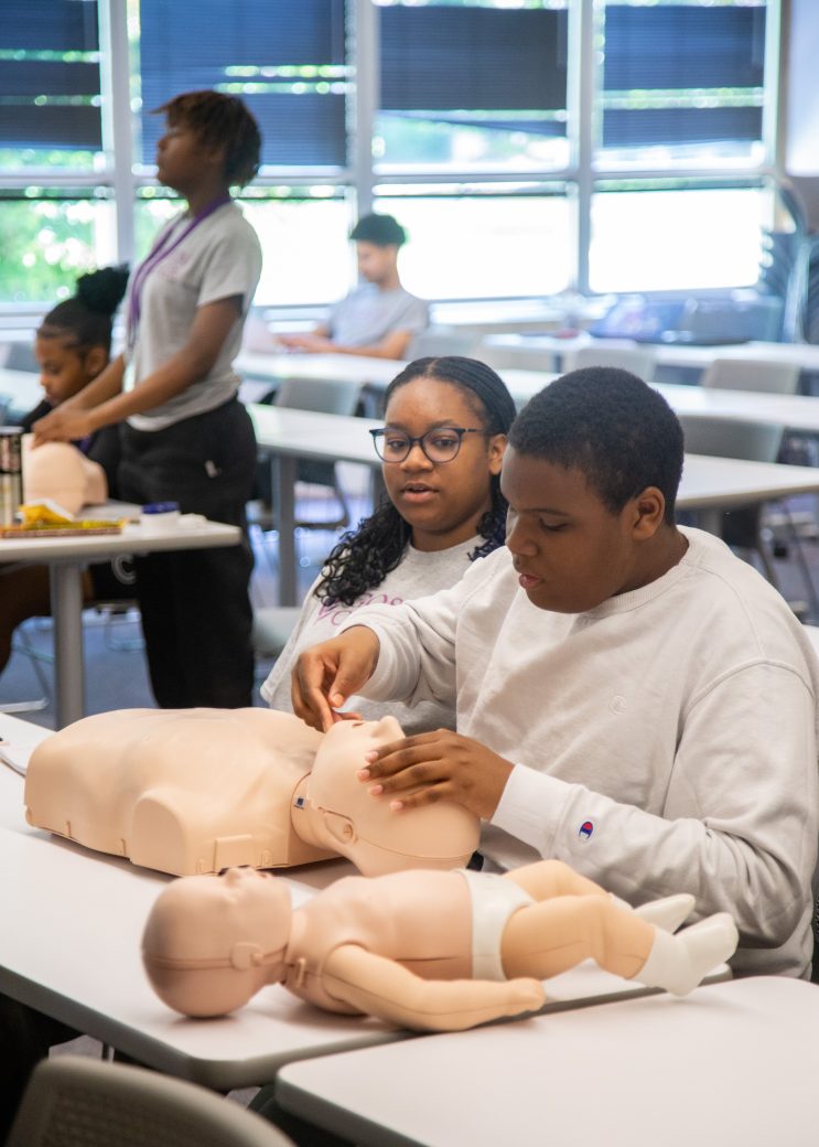 campers work with both adult and infant cpr dummies
