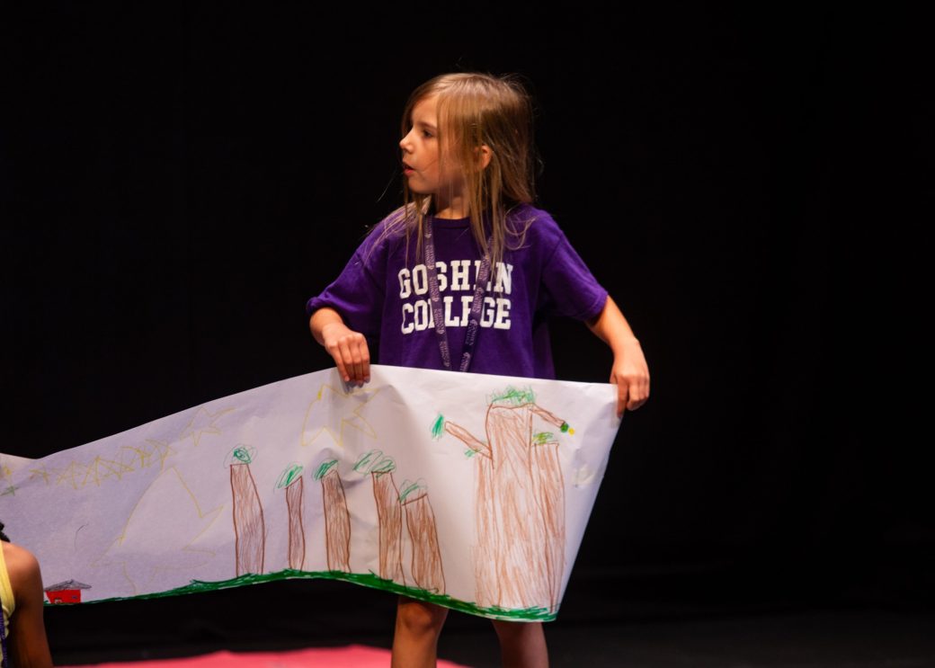 young girl shows off her set work at theater camp