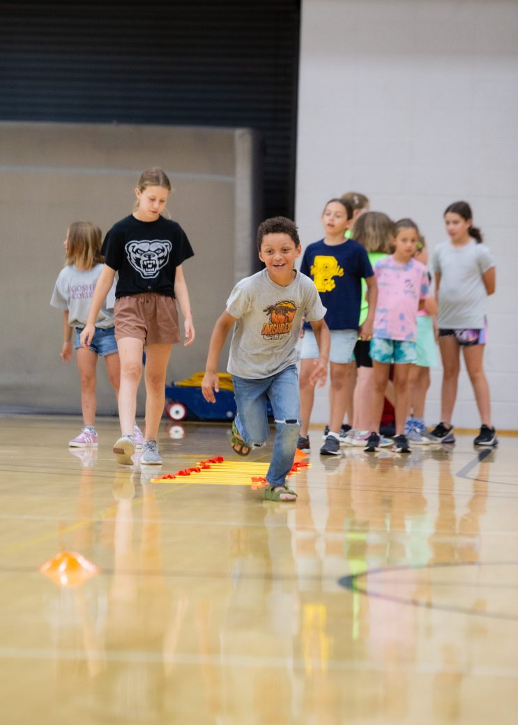 boy running while others wait their turn