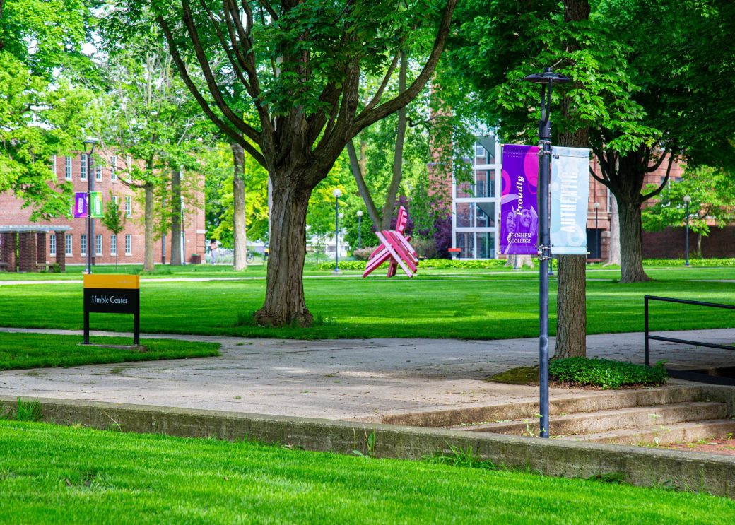 view of broken shield sculpture across a green lawn