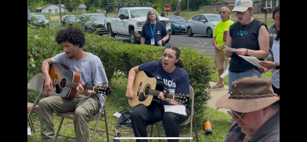 Aysia Adkins singing and playing guitar