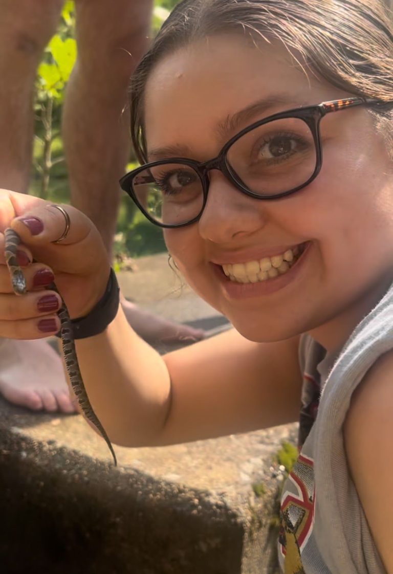 Student holding a lizard