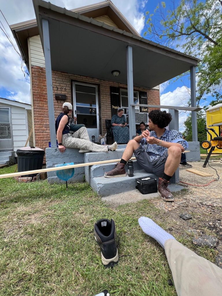 Students taking a break from reconstructing a building