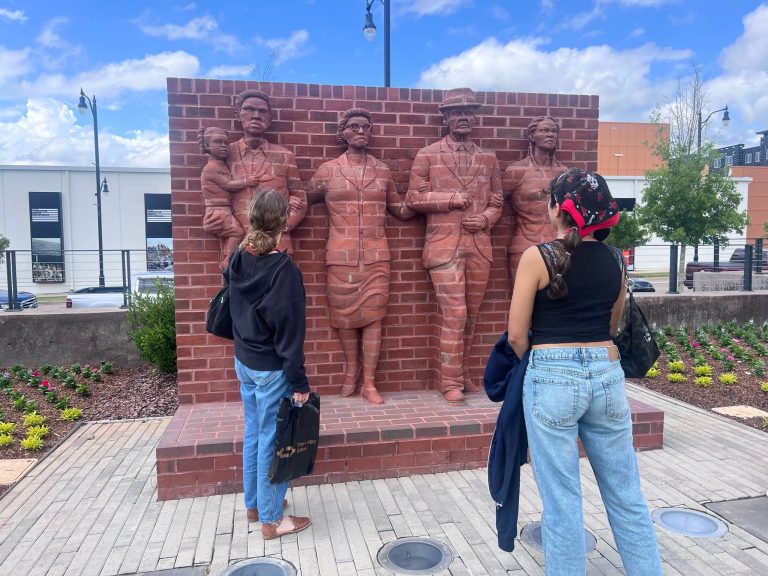 Students in front of a statue