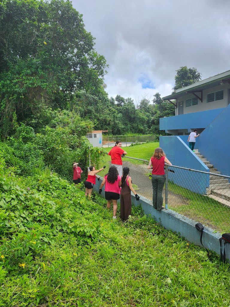 students dressed in neon pink while working in a field