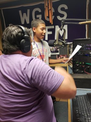 Student reading into microphone