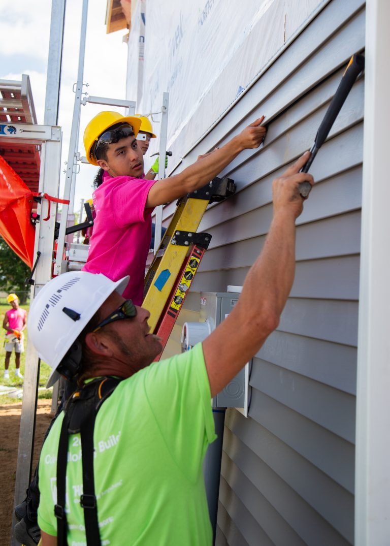 student on ladder