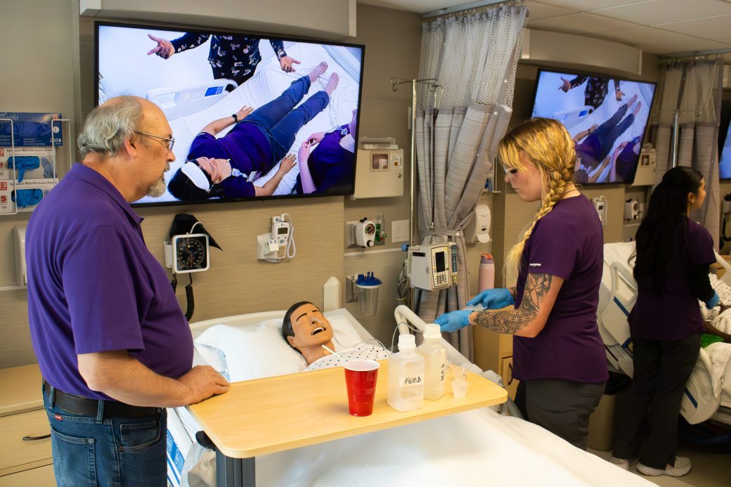 A visitor explores one of the new nursing simulation rooms.