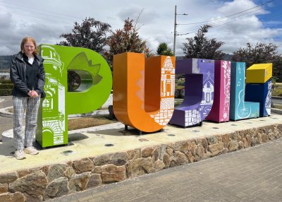 Student infront of Puijili sign