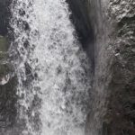 Enjoying the excitement of a waterfall in Mindo.