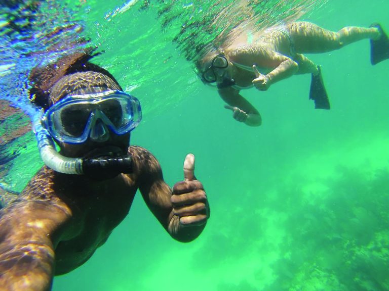 Students posing for a selfie underwater
