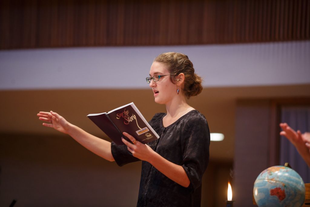 Student singing on stage