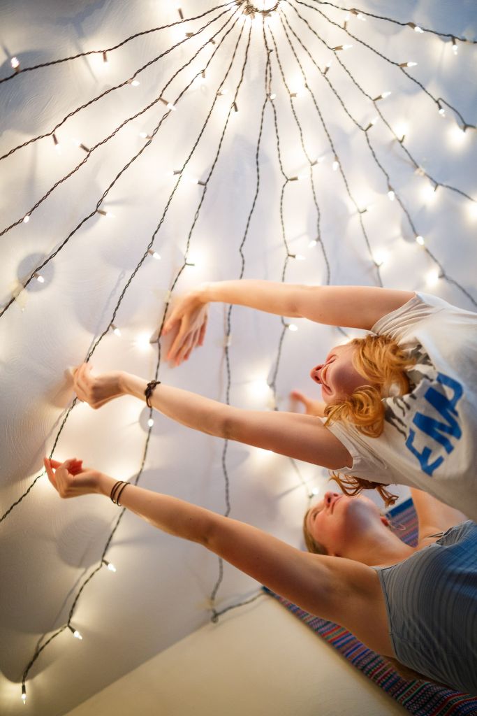 Students decorating their dorm with fairy lights
