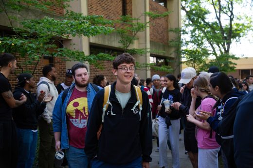 Students excitedly proceeding through a gauntlet of people clapping