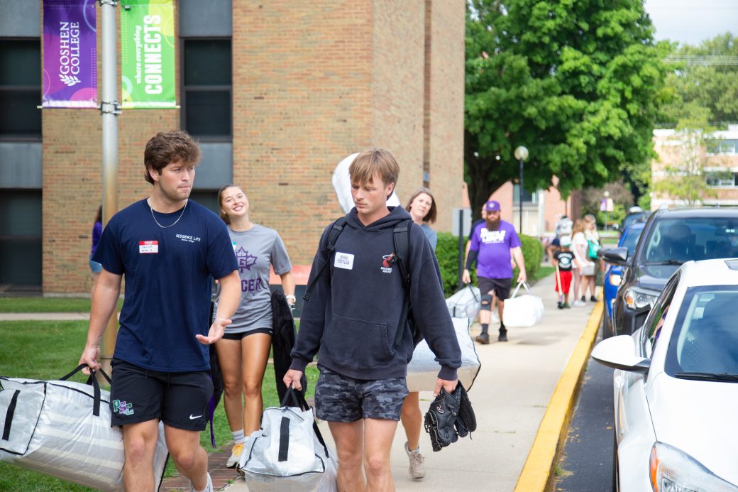 Students carrying items for moving in