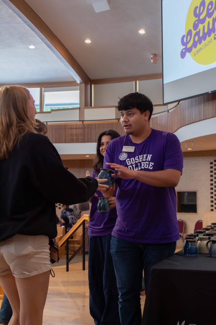 A student receives his mug