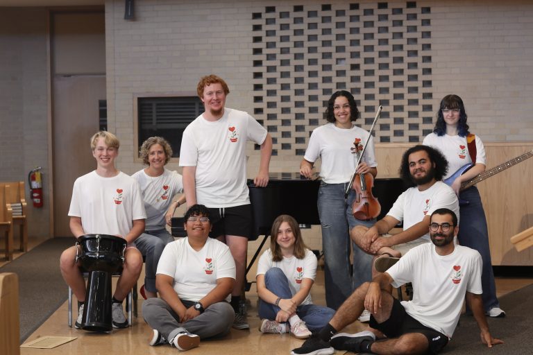 group of students and campus pastor wearing matching white shirts