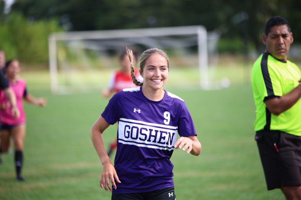 A Goshen College soccer player smiles