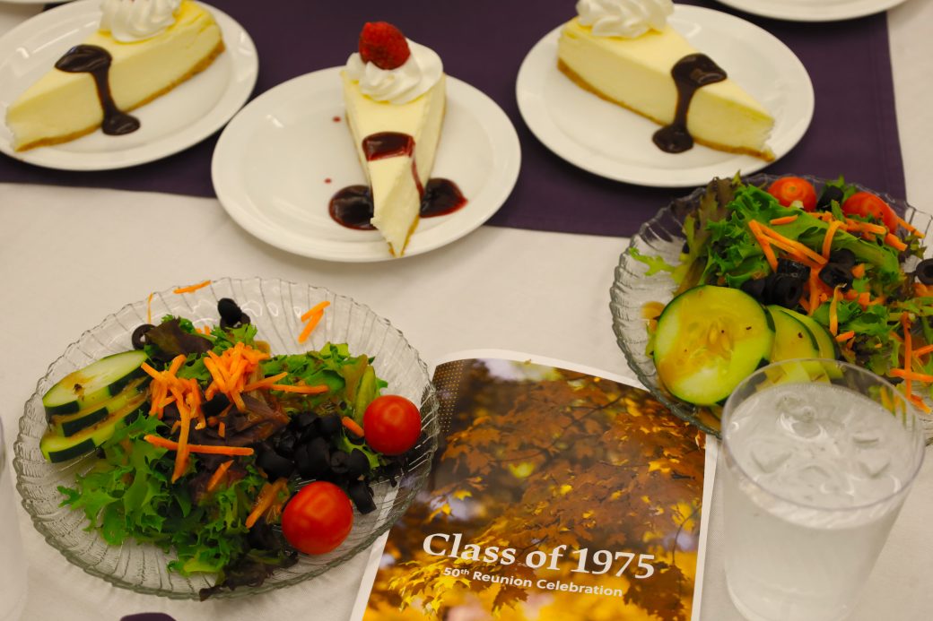 50th class reunion dinner setting with salad and cheesecake