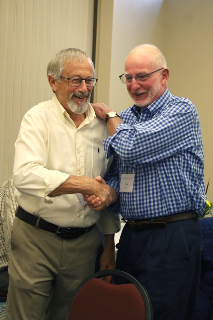 two old friends shaking hands