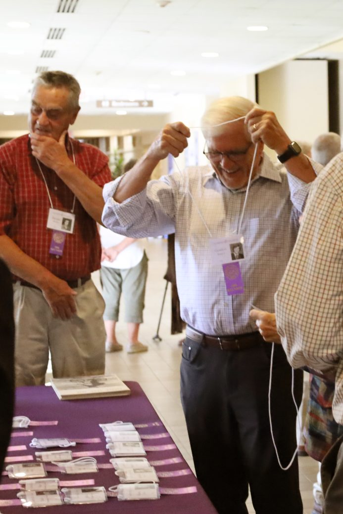 people checking in and grabbing name tags