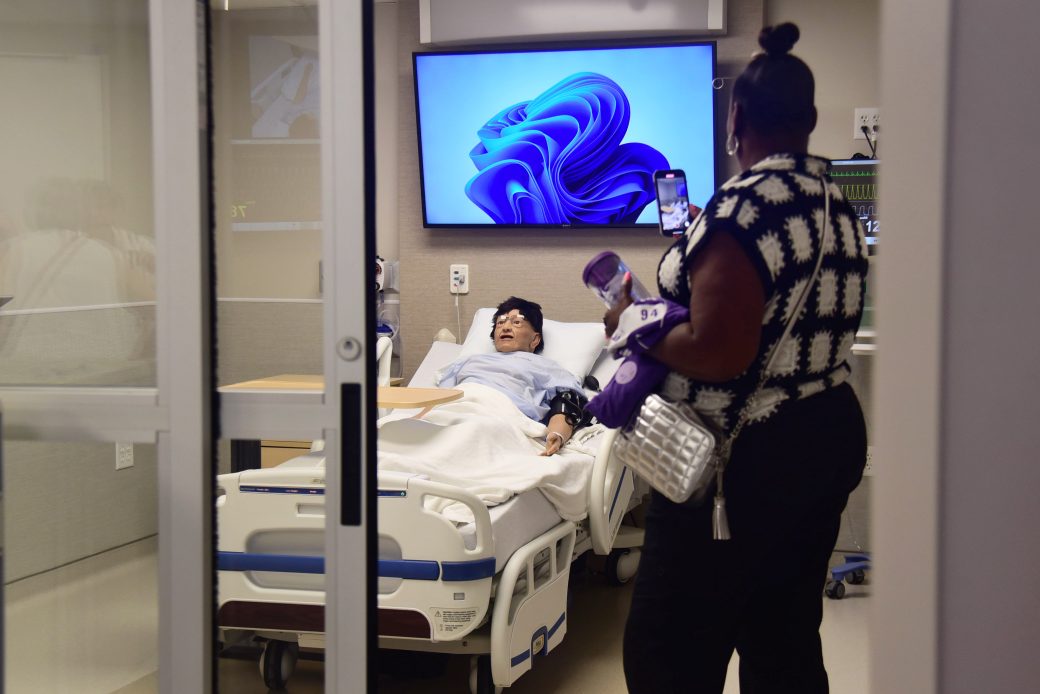 woman in a nursing suite with manikin