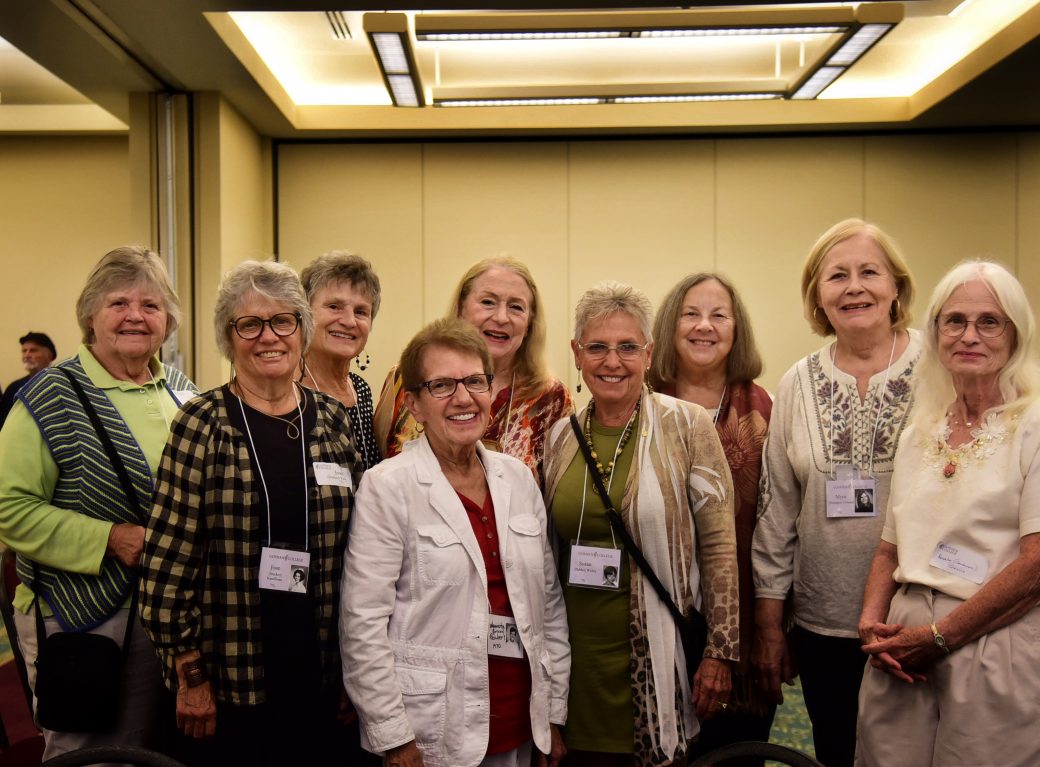 group of older nursing alumni pose for photo