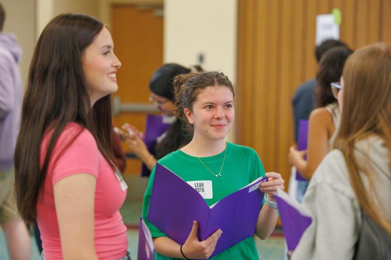 Three new incoming students are chatting together