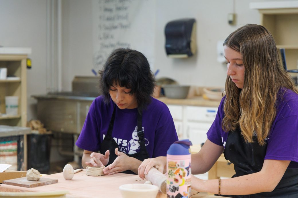 Two summer campers hand building clay