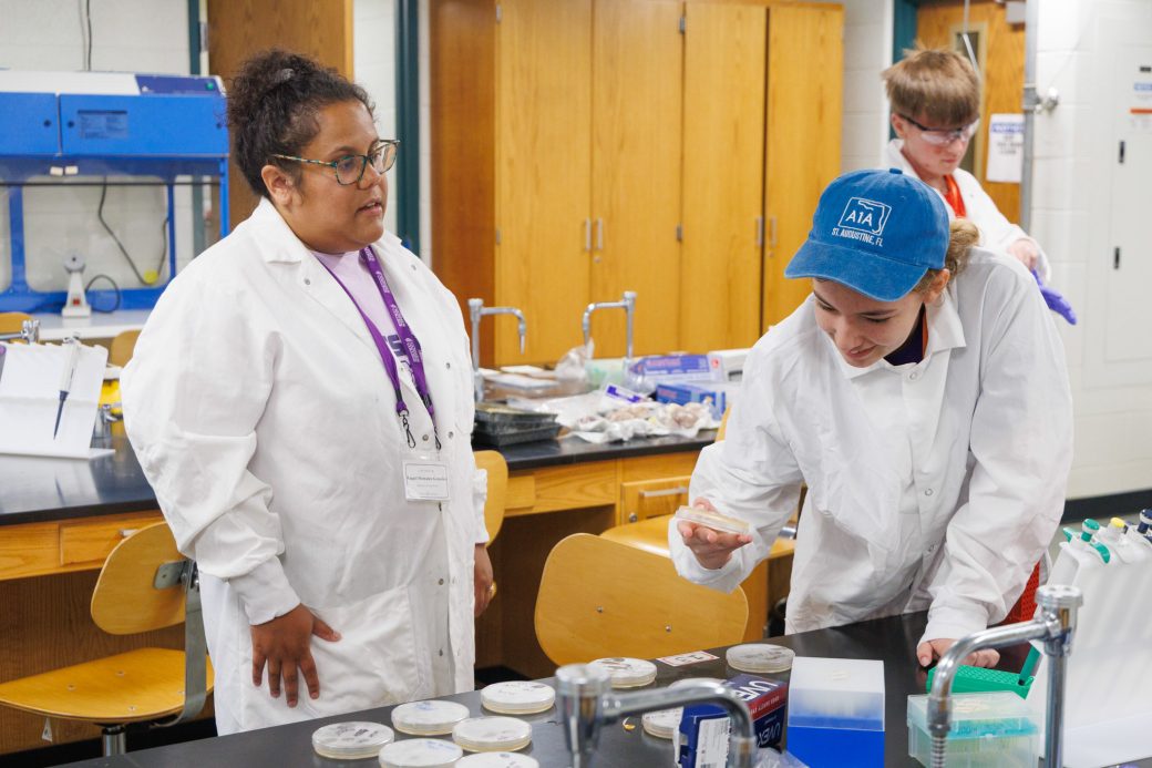 Teacher and summer camper learning in lab