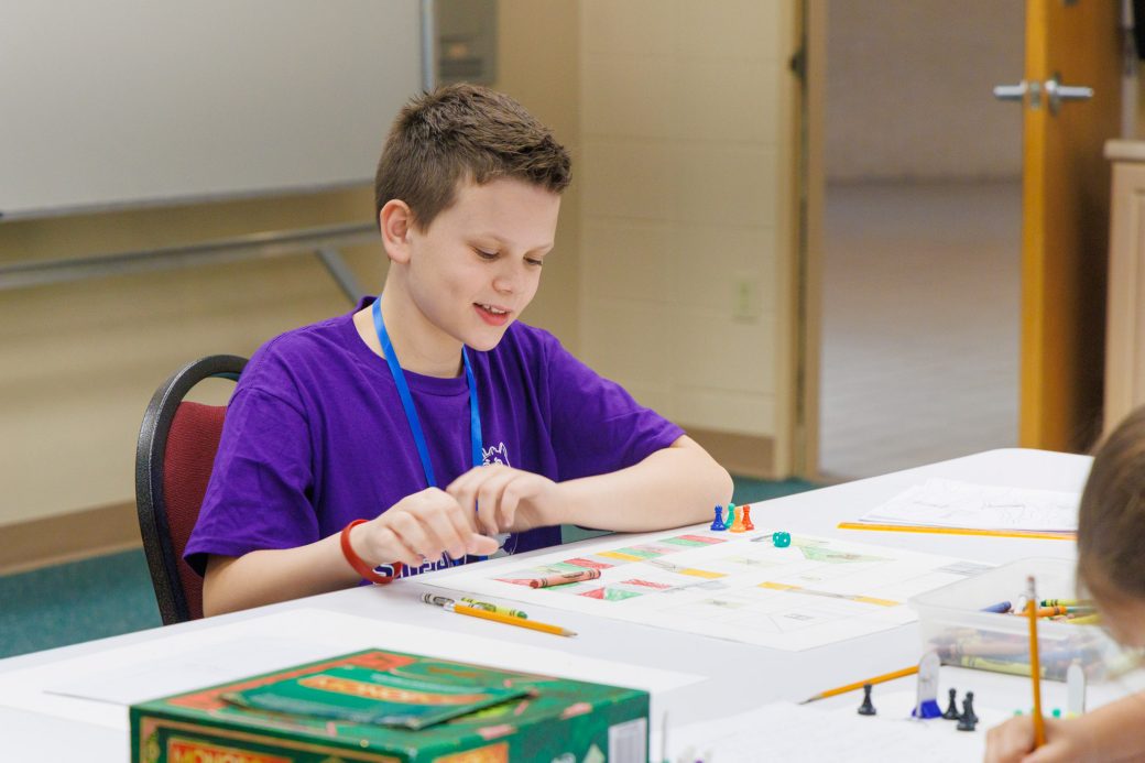 Summer camper working on board game