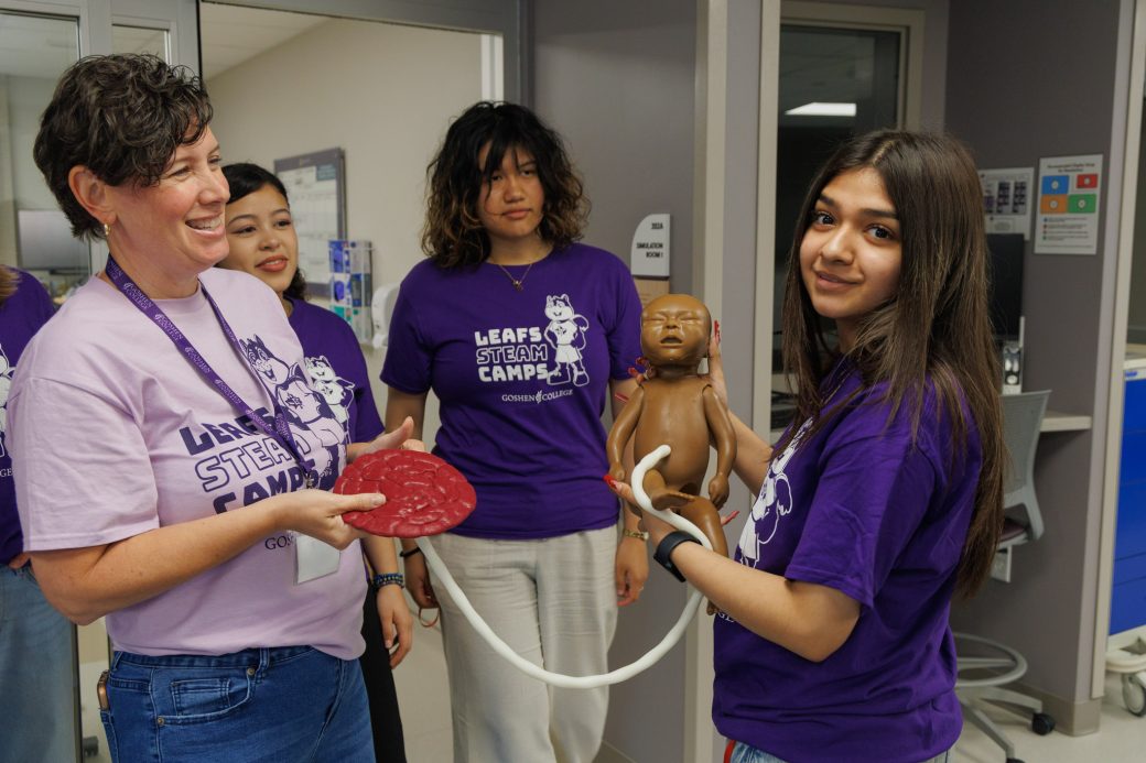 Nursing summer campers holding baby mannequin