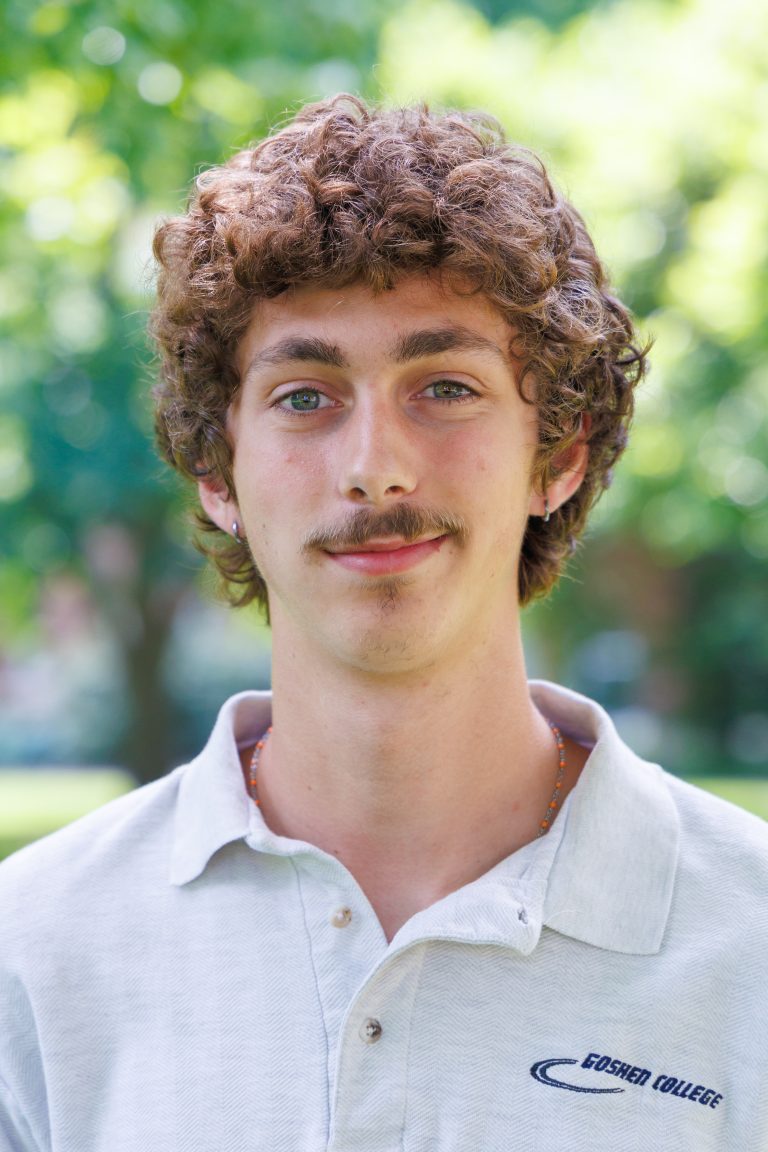 Professional headshot of Max Estep wearing a white polo shirt.