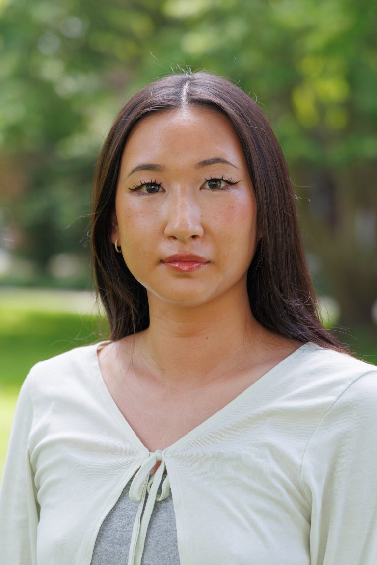 Professional of Ru Sung wearing a white cardigan and a grey top.
