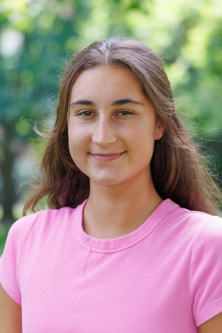 Professional headshot of Sophia Yoder wearing a bubblegum pink t-shirt.