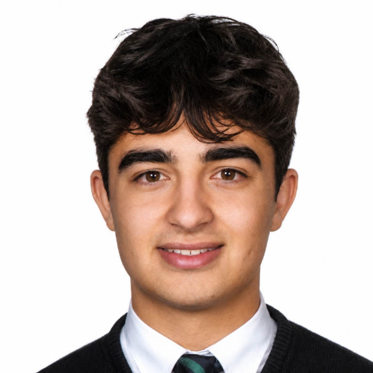professional headshot of Mateo Gonzalez against a white background wearing a white button up and neck tie under a black sweater.
