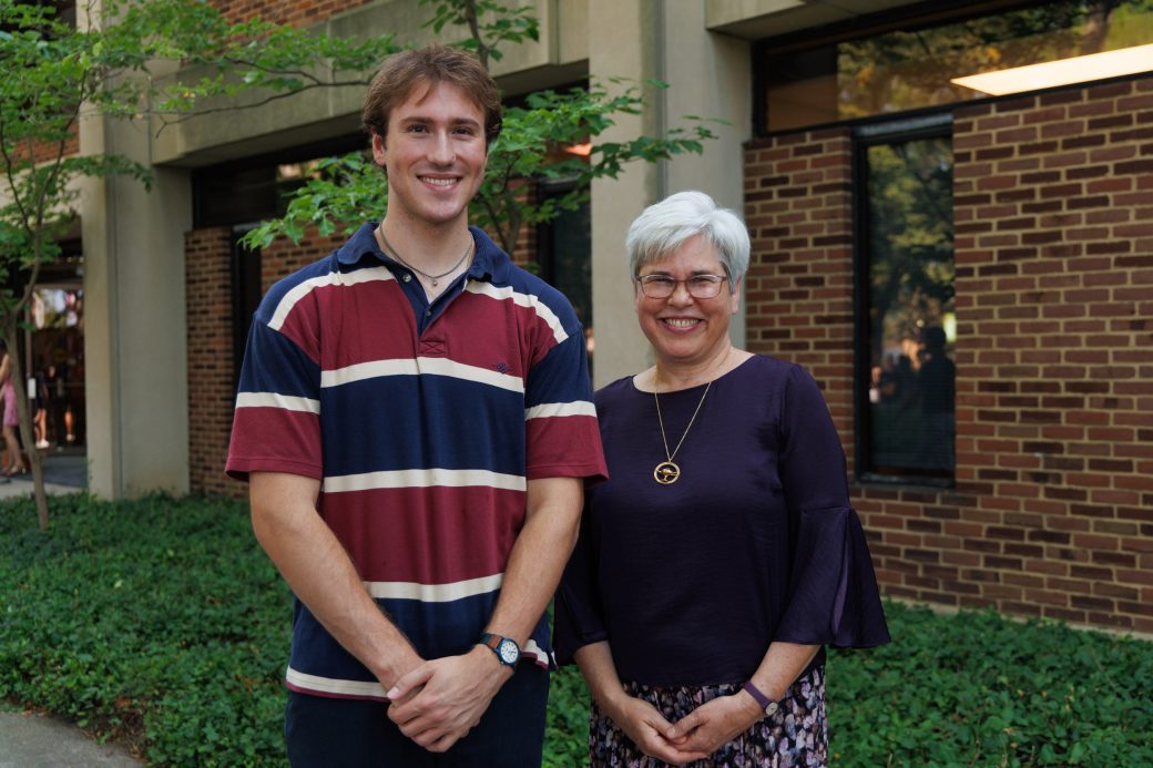 President Rebecca Stoltzfus standing beside student, Ben Koop