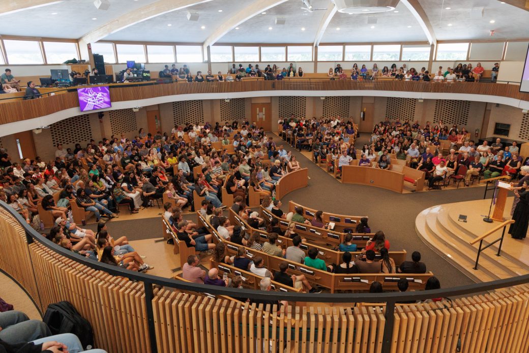 Wide angle of all of campus sitting in church-chapel for opening convocation