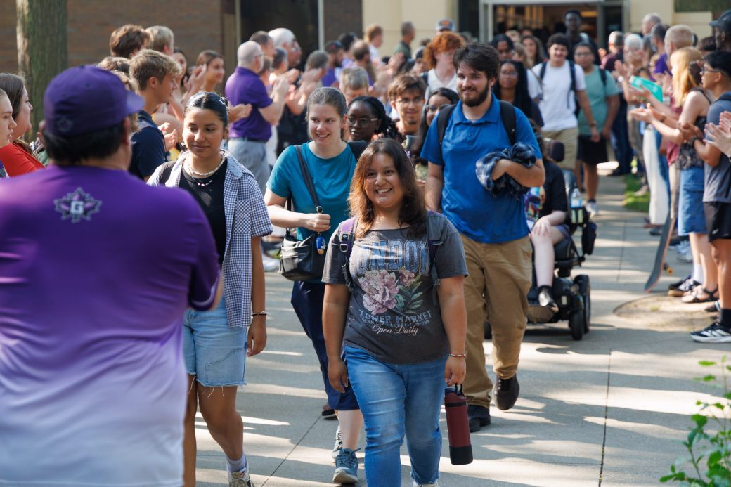 Students walk into Schrock Plaza during annual applause tunnel