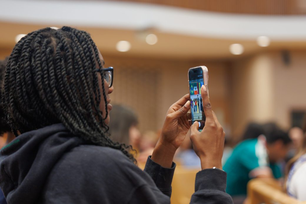 Student grabbing photo of speaker with phone