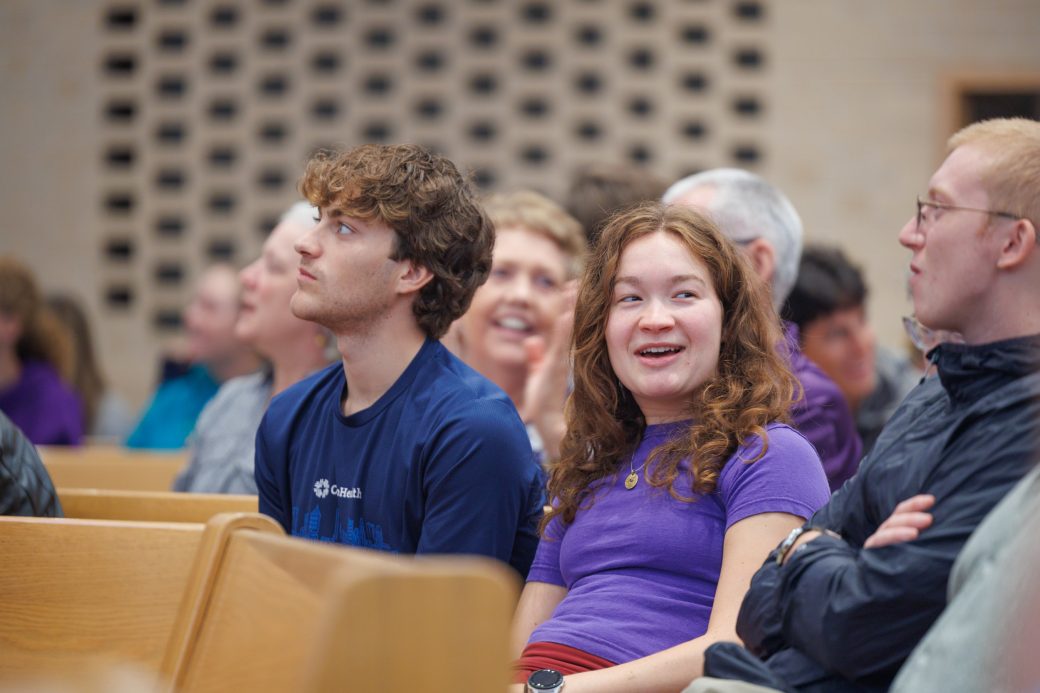 Students smiling in the audience