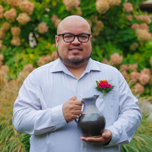 Edgar Saucedo Davila holding the 2026 Young Alumni Servant Leadership Award.