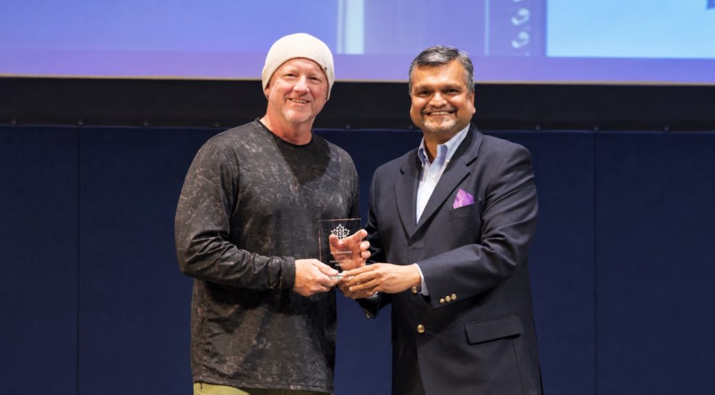 Raj Biyani giving an award to a student