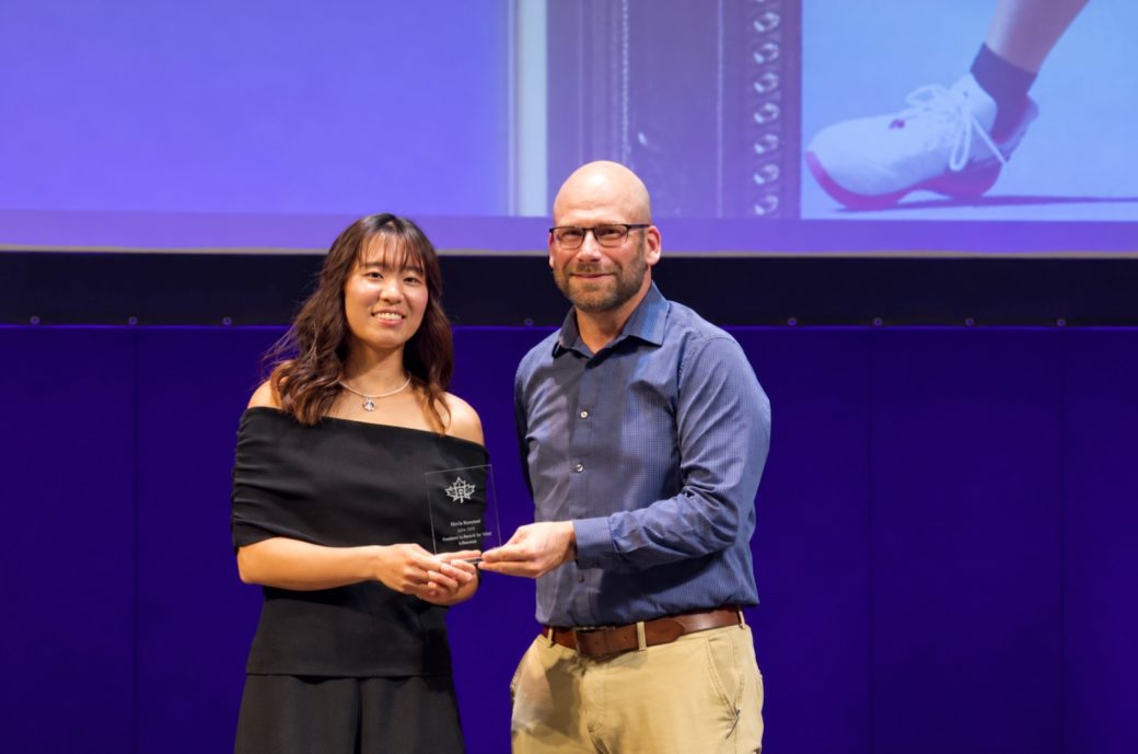 Neal Friesen handing an award to a student