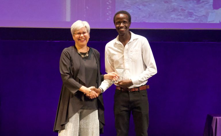 President Rebecca Stoltsfus handing award to student at LEAFYs award show